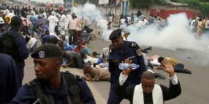 Riot policemen fire tear gas to disperse Catholic priest and demonstrators during a protest against President Joseph Kabila, organized by the Catholic church in Kinshasa, Democratic Republic of Congo January 21, 2018. REUTERS/Kenny Katombe